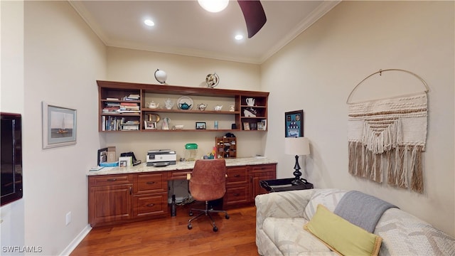 office with recessed lighting, wood finished floors, baseboards, built in study area, and crown molding