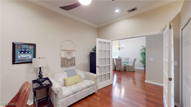 sitting room with french doors, dark wood-style flooring, visible vents, ornamental molding, and baseboards