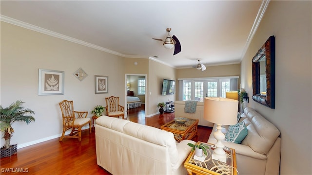 living area featuring baseboards, dark wood-style flooring, a ceiling fan, and crown molding