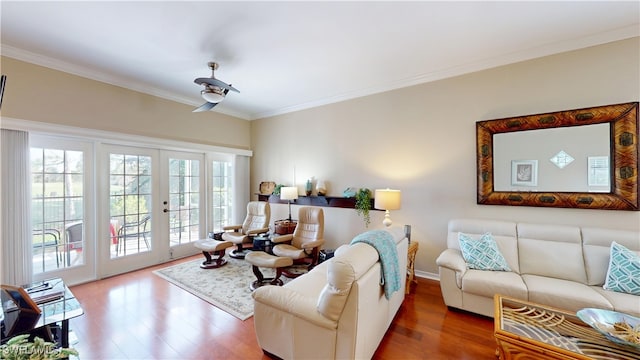 living area featuring french doors, crown molding, and wood finished floors