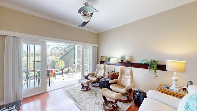 sitting room featuring crown molding and wood finished floors