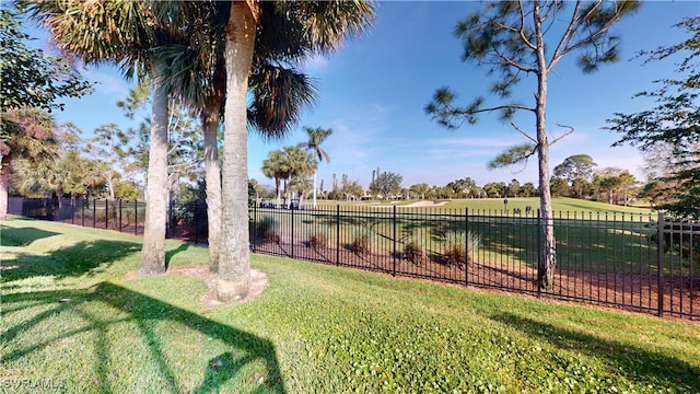 view of yard featuring fence and a rural view