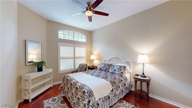 bedroom with ceiling fan, baseboards, and dark wood-type flooring