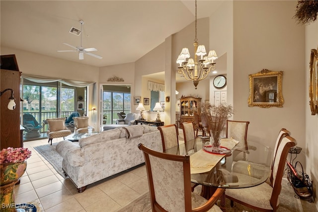 dining room with high vaulted ceiling, light tile patterned flooring, visible vents, and ceiling fan with notable chandelier