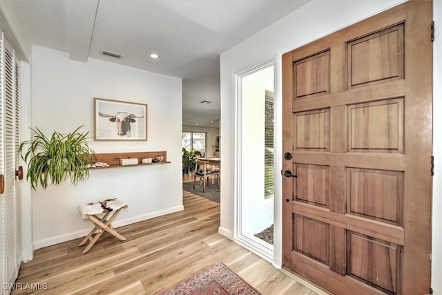 entryway with light wood finished floors, recessed lighting, visible vents, and baseboards