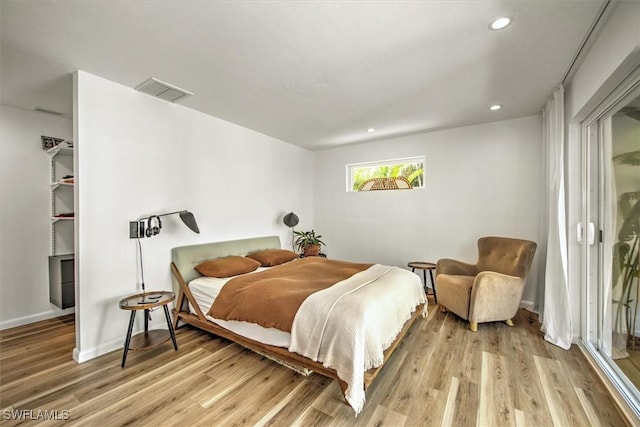 bedroom featuring baseboards, visible vents, a walk in closet, light wood-type flooring, and recessed lighting