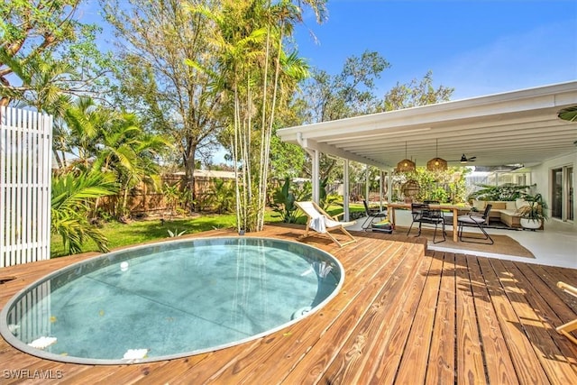 view of pool featuring a fenced backyard and a deck