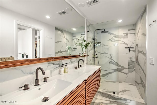 bathroom with marble finish floor, visible vents, a sink, and a marble finish shower