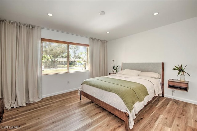 bedroom with recessed lighting, baseboards, and wood finished floors