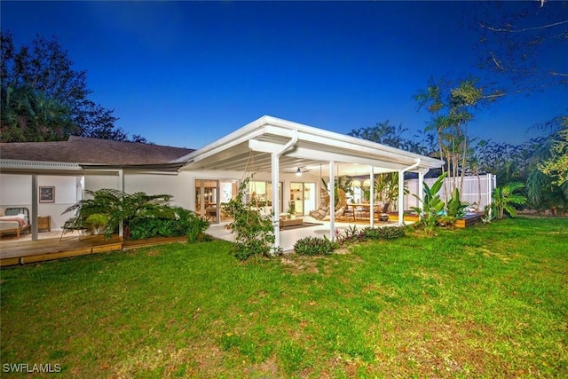 rear view of property with a patio area and a lawn