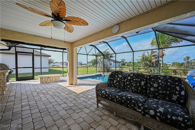 view of patio / terrace with an outdoor pool, area for grilling, glass enclosure, ceiling fan, and an outdoor hangout area