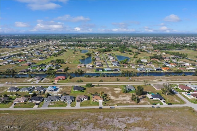 bird's eye view featuring a residential view and a water view