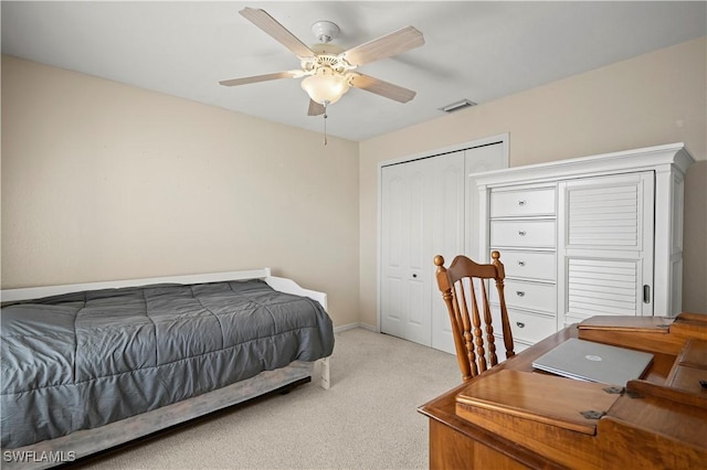 bedroom with ceiling fan, light carpet, visible vents, baseboards, and a closet