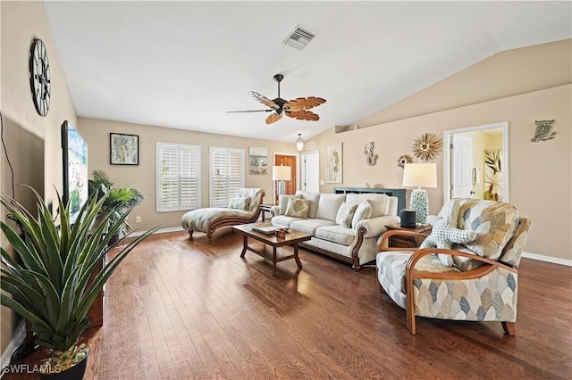 living area with lofted ceiling, visible vents, dark wood finished floors, and baseboards