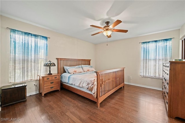 bedroom featuring dark wood-style floors, ceiling fan, and baseboards