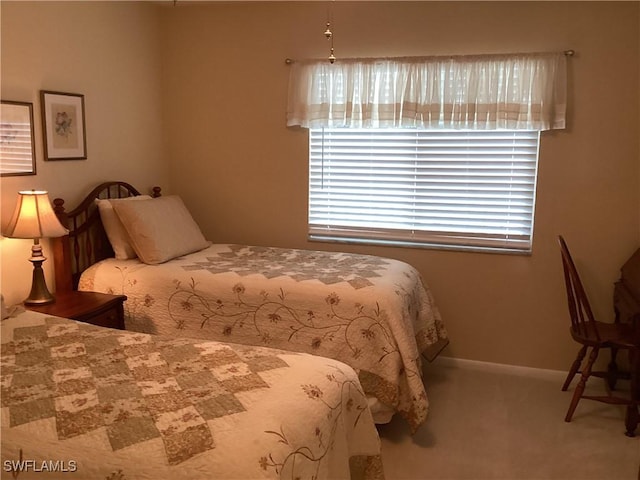 carpeted bedroom featuring baseboards