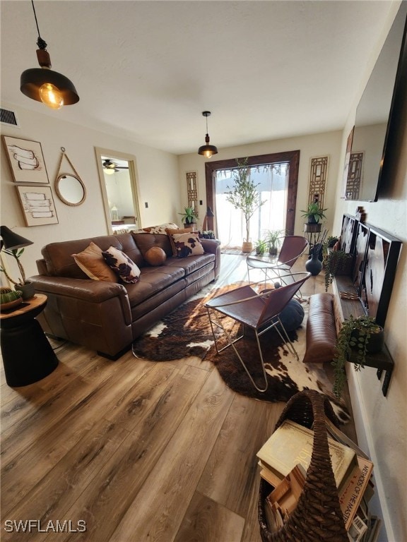 living room with visible vents and wood finished floors