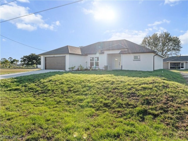 single story home featuring an attached garage, a front lawn, concrete driveway, and stucco siding