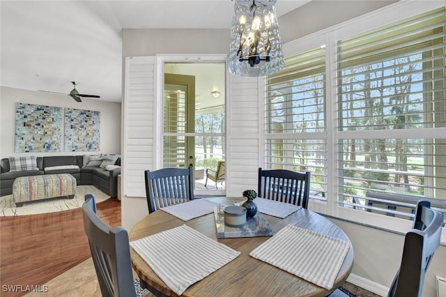 dining room featuring ceiling fan with notable chandelier and plenty of natural light