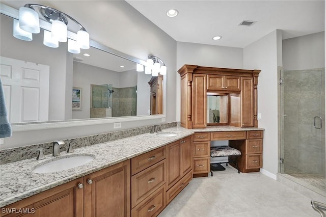 bathroom with double vanity, a stall shower, visible vents, and a sink