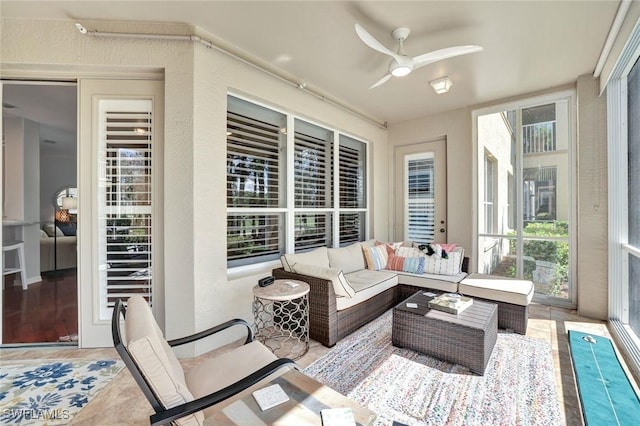 sunroom with a ceiling fan