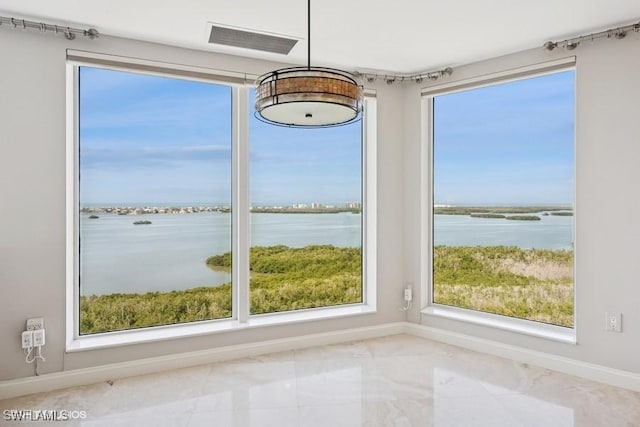 interior space featuring a water view, visible vents, and baseboards