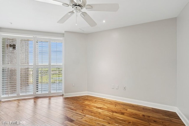 spare room with ceiling fan, baseboards, and wood finished floors