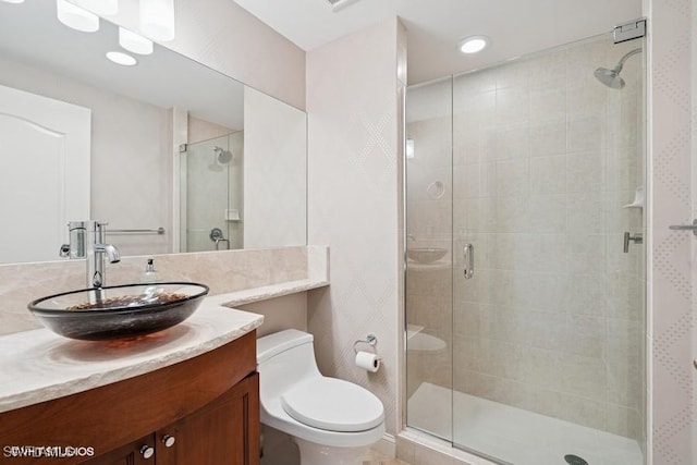 full bath with a shower stall, toilet, and vanity