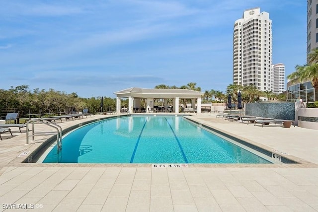 community pool with a patio area and a gazebo