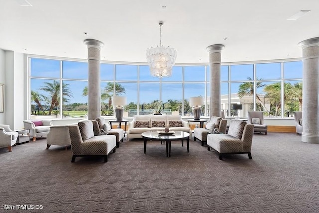 sunroom / solarium featuring decorative columns and an inviting chandelier