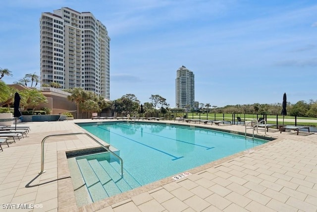 pool featuring a patio area and a view of city