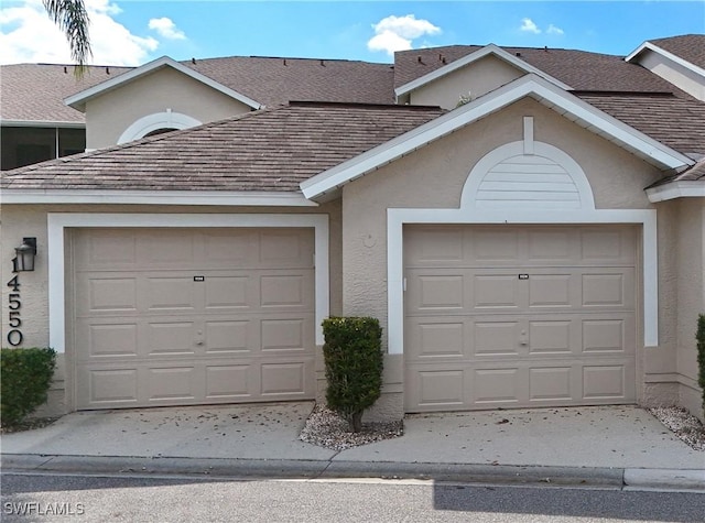 garage featuring concrete driveway