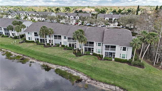 drone / aerial view with a water view and a residential view