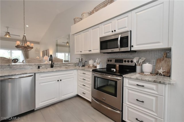 kitchen with white cabinets, tasteful backsplash, stainless steel appliances, and a sink