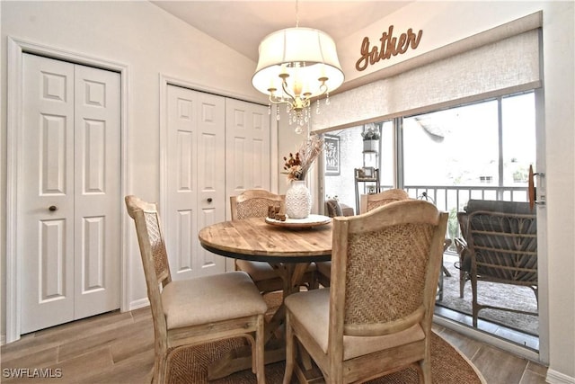 dining room with a chandelier and wood finished floors