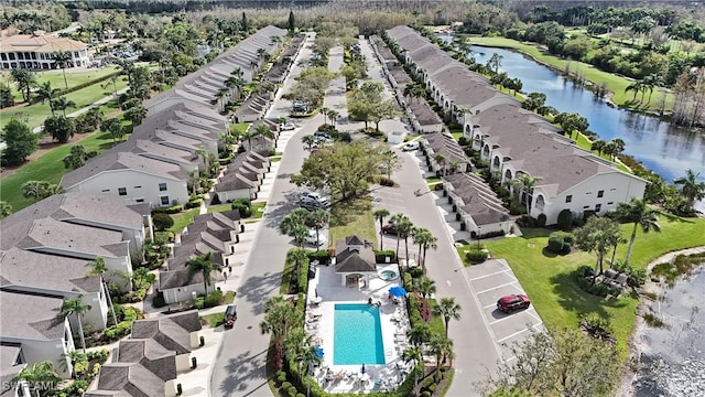 drone / aerial view featuring a water view and a residential view