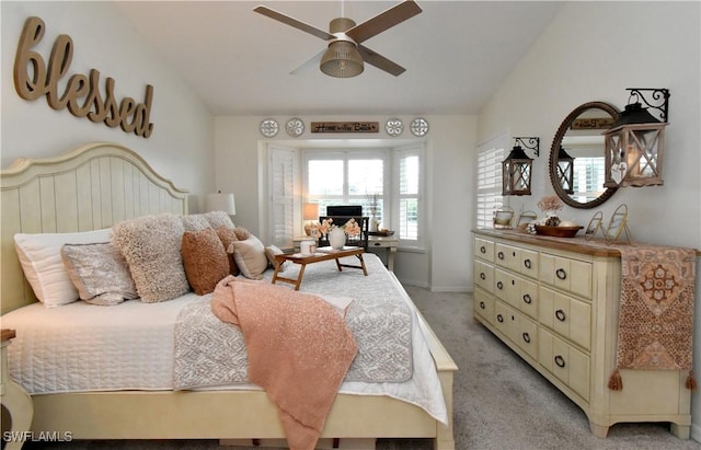 bedroom featuring lofted ceiling, a ceiling fan, and light colored carpet