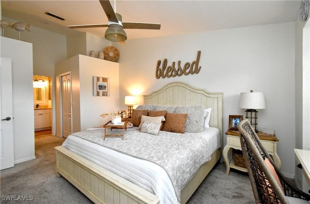 carpeted bedroom featuring lofted ceiling, ensuite bath, visible vents, and a ceiling fan