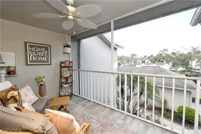 balcony with a residential view and ceiling fan