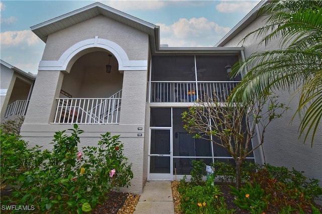 entrance to property featuring stucco siding