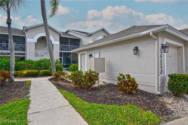 view of home's exterior with an attached garage and stucco siding