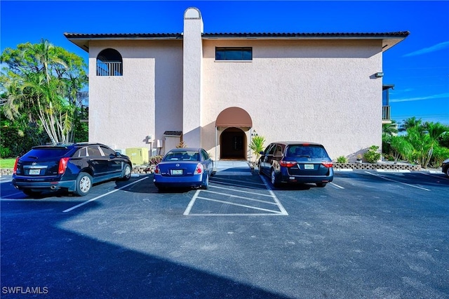 view of property with uncovered parking