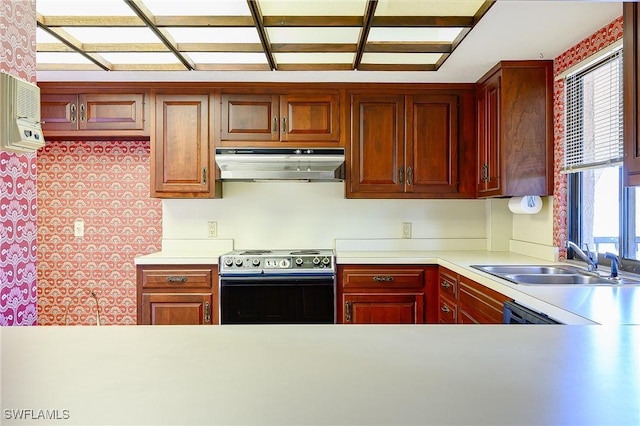 kitchen featuring electric range oven, light countertops, a sink, and under cabinet range hood