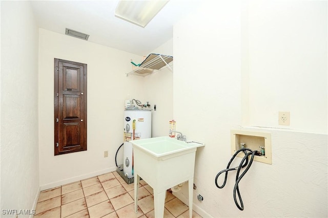 laundry room with light tile patterned floors, hookup for a washing machine, water heater, visible vents, and laundry area