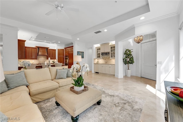 living area with light tile patterned flooring, recessed lighting, baseboards, ornamental molding, and a raised ceiling