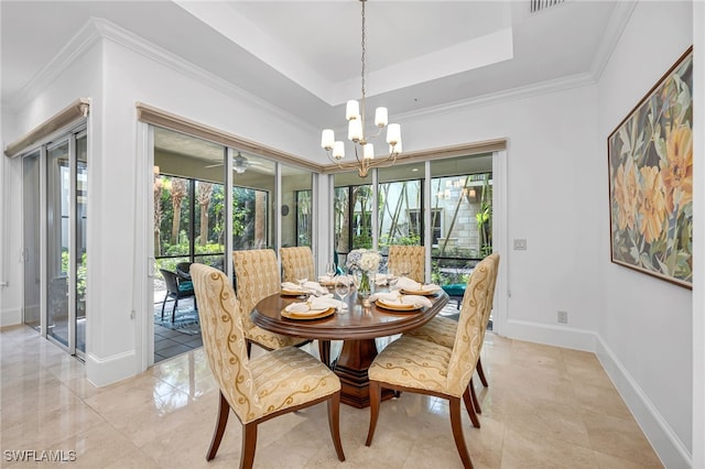 dining space featuring a chandelier, ornamental molding, a raised ceiling, and baseboards