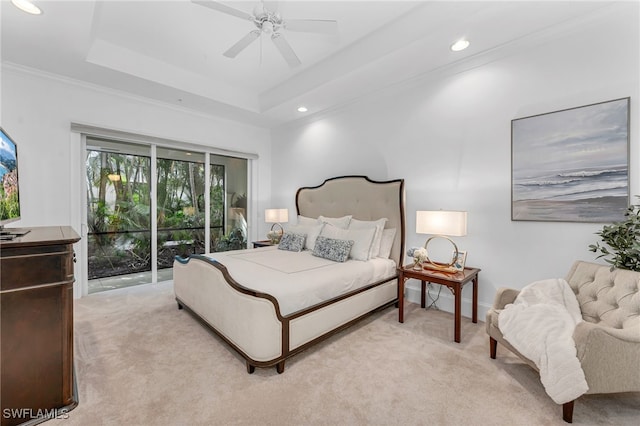 bedroom with recessed lighting, light colored carpet, a ceiling fan, access to outside, and a tray ceiling