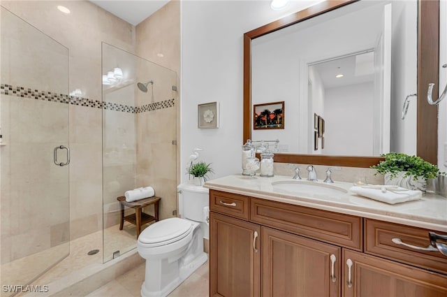 bathroom with tile patterned floors, a shower stall, toilet, and vanity