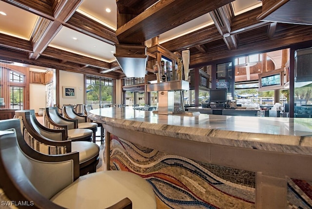 interior space with coffered ceiling, crown molding, and beamed ceiling