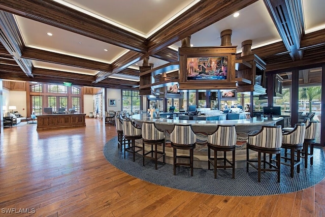 bar with coffered ceiling, wood finished floors, and beamed ceiling